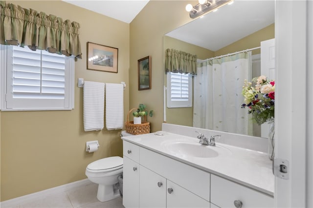 bathroom with vanity, plenty of natural light, tile patterned floors, and toilet