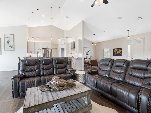 living room featuring vaulted ceiling, dark wood-type flooring, and ceiling fan