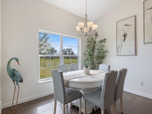 dining space featuring vaulted ceiling, dark hardwood / wood-style floors, and a chandelier