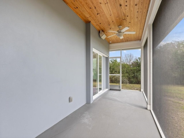 unfurnished sunroom with wooden ceiling and ceiling fan