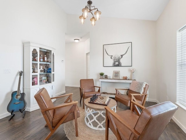 living area with dark hardwood / wood-style flooring and a chandelier