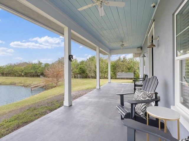 view of patio / terrace with a water view and ceiling fan