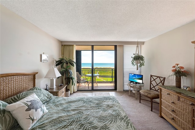 carpeted bedroom with floor to ceiling windows, access to exterior, and a textured ceiling