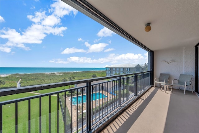 balcony with a beach view and a water view