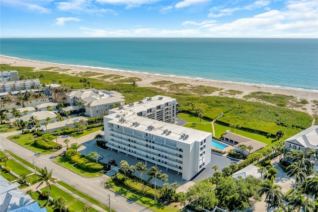 bird's eye view with a water view and a beach view