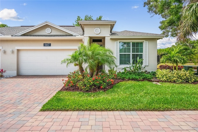 view of front of home with a garage and a front yard