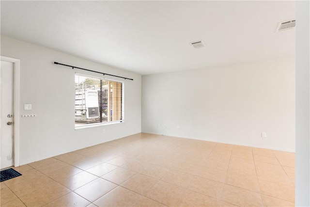 spare room with light tile patterned floors