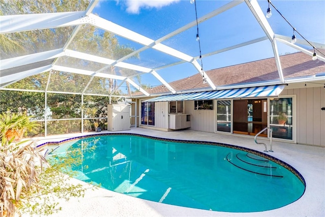 pool with glass enclosure and a patio