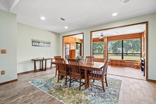 dining space with wood finished floors, ceiling fan, baseboards, and recessed lighting