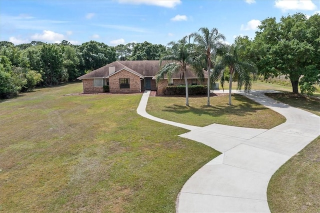 view of front facade with a front yard and brick siding