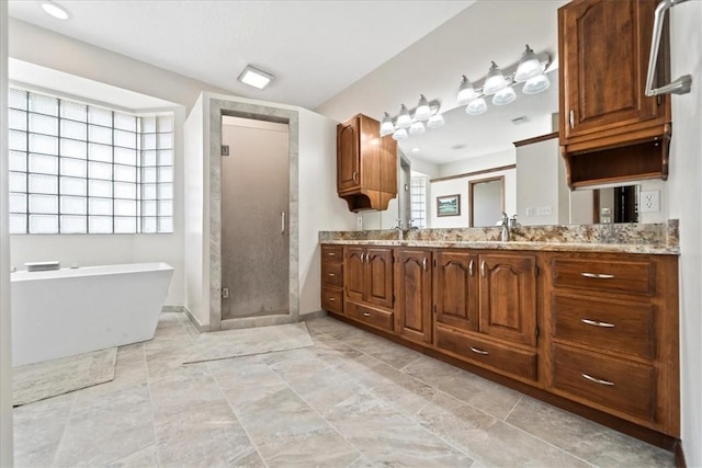 bathroom with vanity, baseboards, a soaking tub, a shower stall, and visible vents