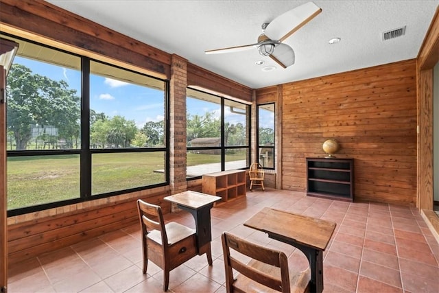 sunroom / solarium with visible vents and a ceiling fan