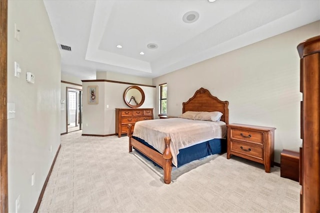 bedroom with visible vents, baseboards, a tray ceiling, recessed lighting, and light carpet