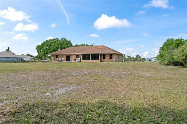 back of property featuring a lawn