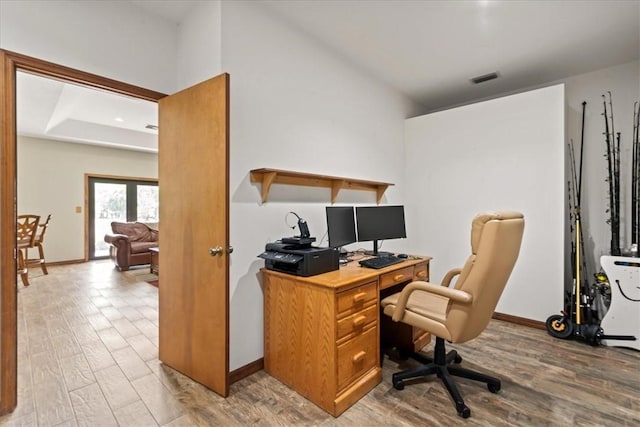 office featuring visible vents, light wood-style flooring, and baseboards
