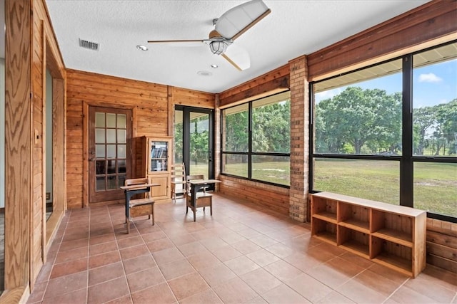 sunroom / solarium with visible vents, ceiling fan, and a healthy amount of sunlight