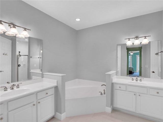 bathroom with vanity, shower with separate bathtub, and tile patterned flooring