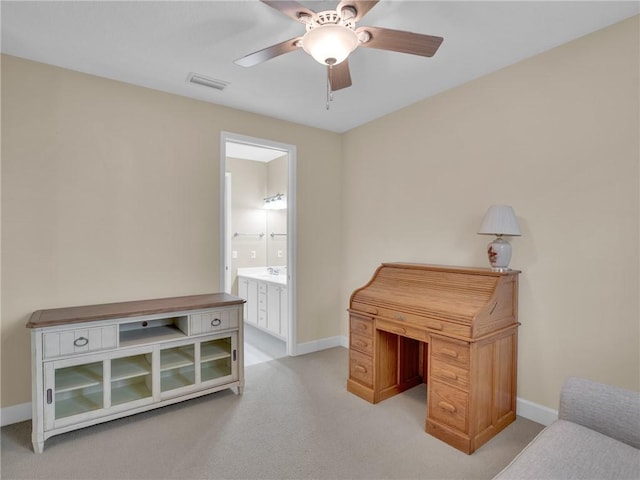 carpeted office space featuring ceiling fan