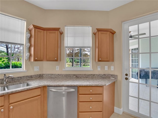 kitchen with sink, light tile patterned flooring, ceiling fan, stainless steel dishwasher, and light stone countertops