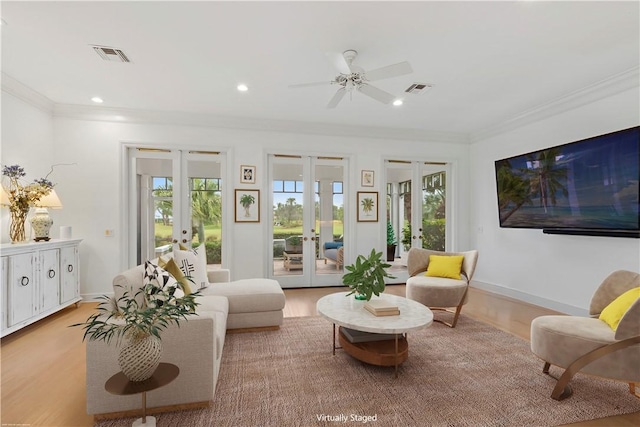 living room featuring ceiling fan, french doors, plenty of natural light, and light hardwood / wood-style floors