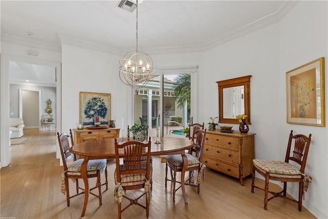 dining room featuring a notable chandelier, crown molding, and light hardwood / wood-style flooring