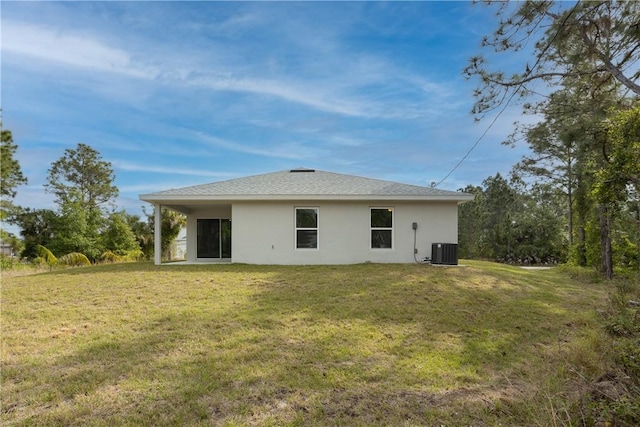 901 Brickell St SE, Palm Bay, FL 32909 - back of house featuring stucco siding and a yard