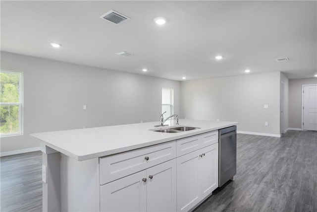 901 Brickell St SE, Palm Bay, FL 32909 - kitchen featuring dishwasher, a kitchen island with sink, light countertops, recessed lighting, and white cabinets