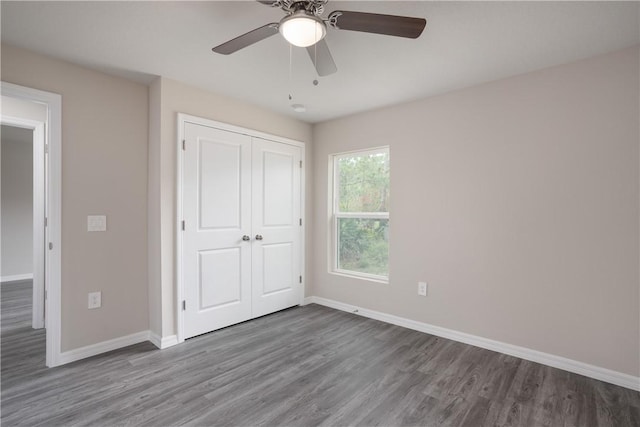 901 Brickell St SE, Palm Bay, FL 32909 - unfurnished bedroom featuring wood finished floors, a closet, and a ceiling fan