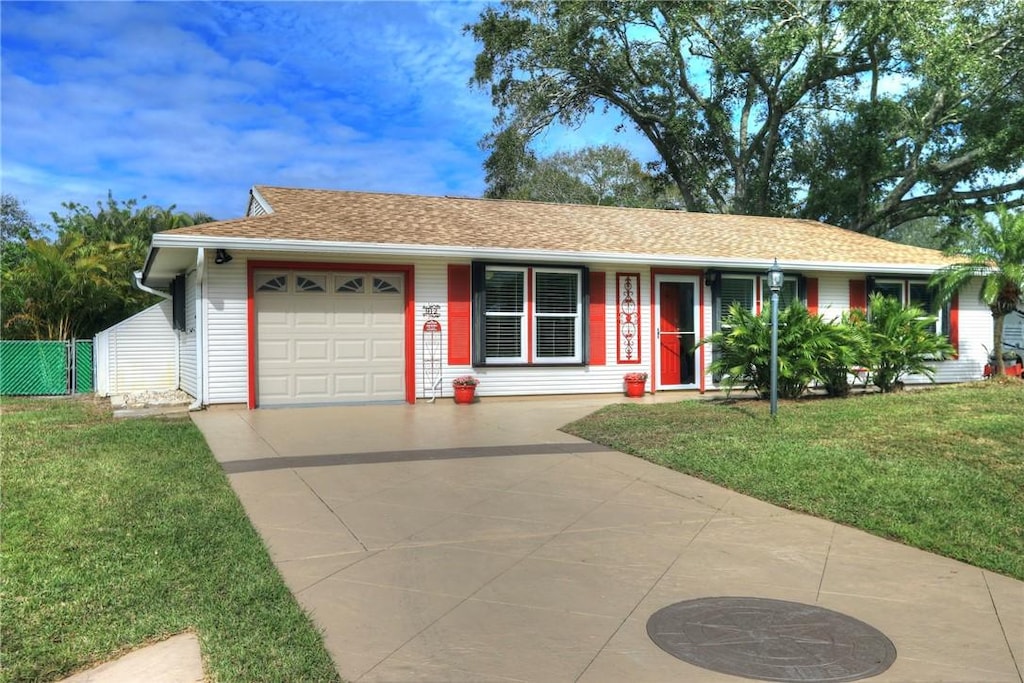 ranch-style home featuring a garage and a front yard