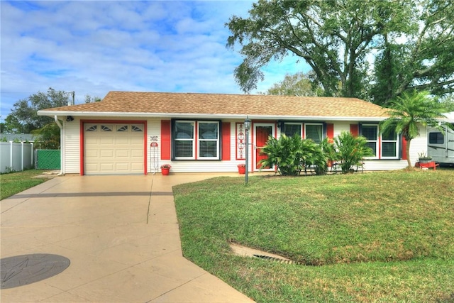 ranch-style house with a garage and a front lawn