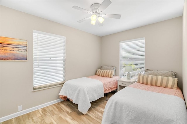 bedroom featuring light wood-style flooring, baseboards, and ceiling fan