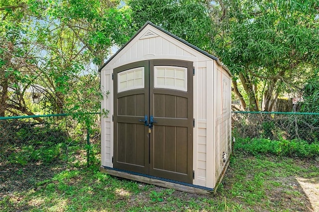 view of shed featuring fence