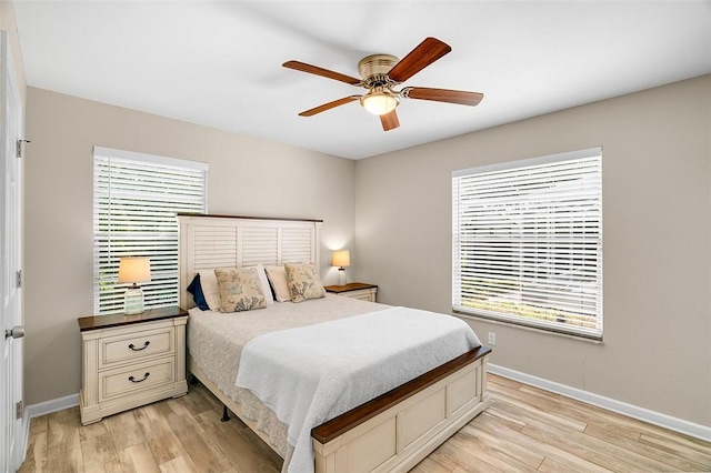 bedroom featuring light wood-style floors, baseboards, and ceiling fan