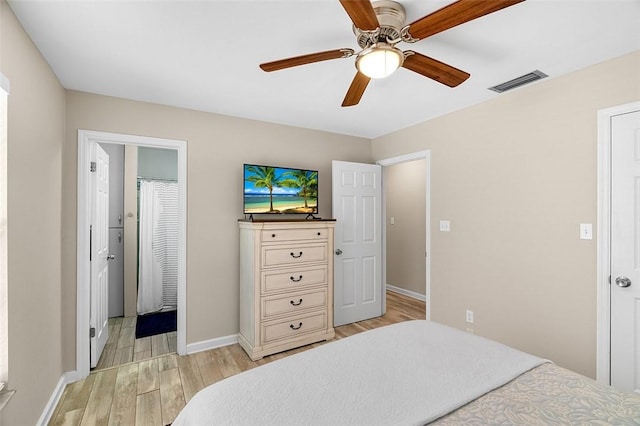 bedroom featuring visible vents, baseboards, light wood-style floors, and ceiling fan