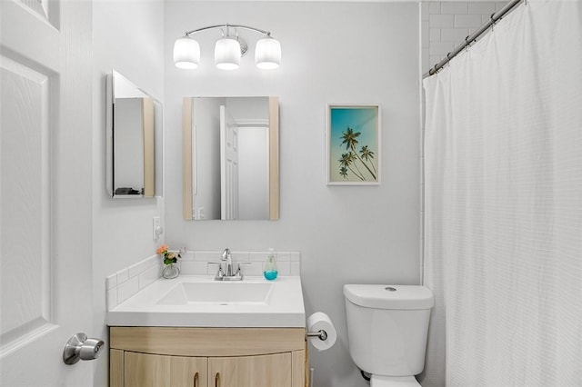 full bathroom with toilet, vanity, and a shower with curtain