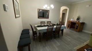 dining room featuring hardwood / wood-style floors and a chandelier