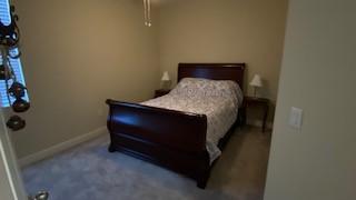 carpeted bedroom featuring ceiling fan and a closet