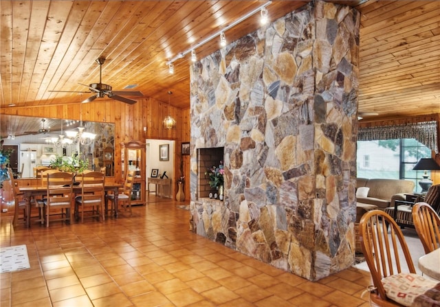 living room featuring wood walls, track lighting, ceiling fan, high vaulted ceiling, and wood ceiling