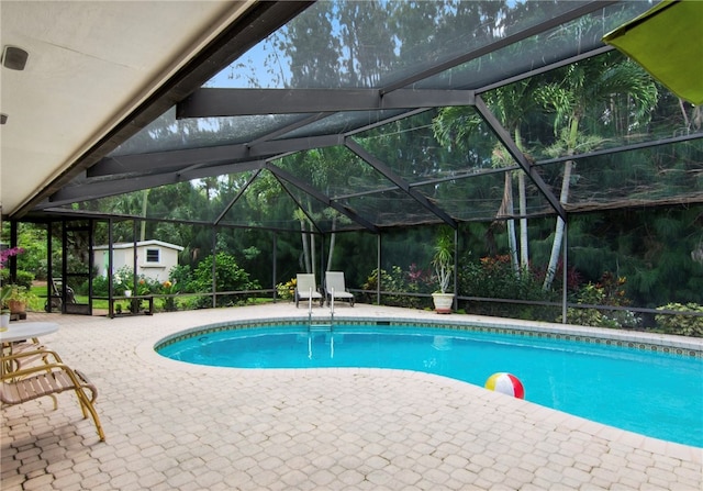 view of pool with a lanai and a patio