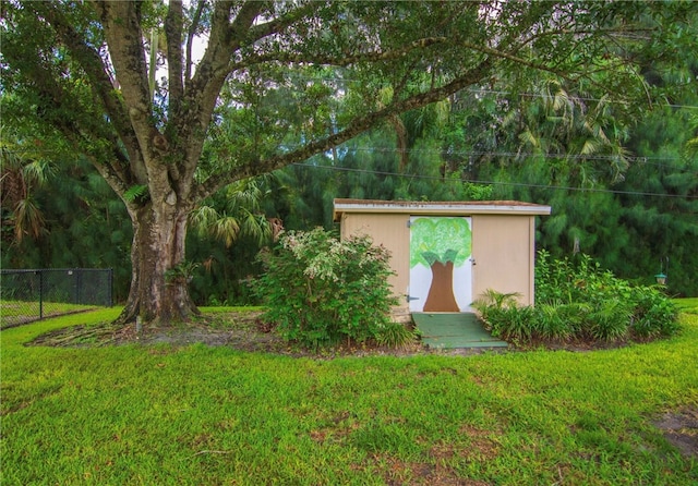 view of outdoor structure featuring a lawn