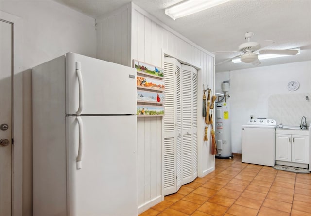 kitchen featuring ceiling fan, a textured ceiling, washer / dryer, electric water heater, and white fridge