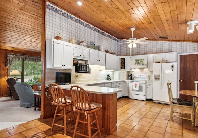 kitchen with white cabinetry, white appliances, light carpet, and ceiling fan