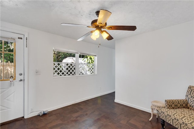 interior space featuring ceiling fan and a textured ceiling