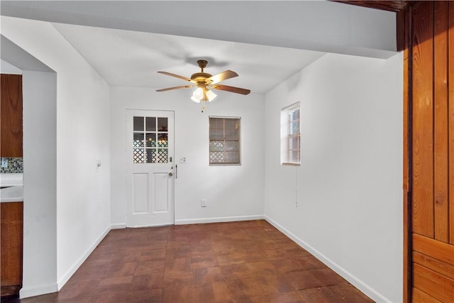 interior space with ceiling fan