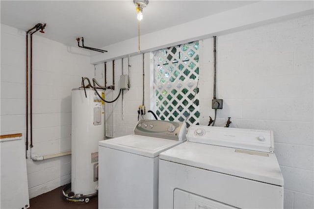 laundry area featuring electric water heater and independent washer and dryer