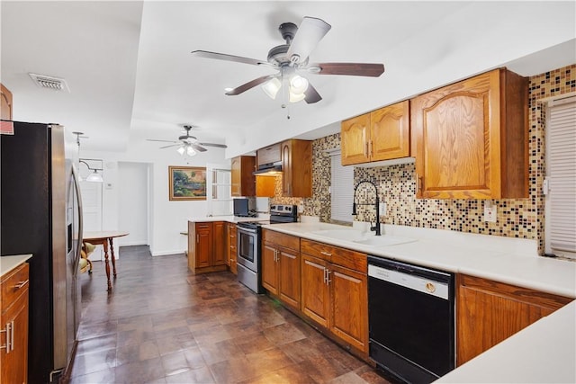 kitchen with tasteful backsplash, appliances with stainless steel finishes, sink, and ceiling fan