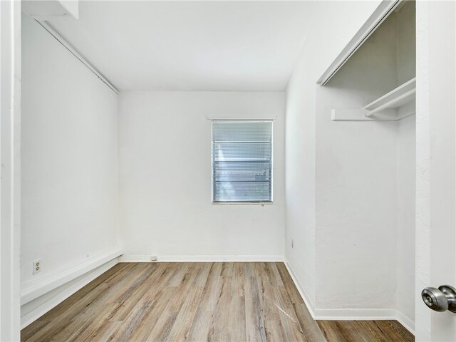 walk in closet with light wood-type flooring