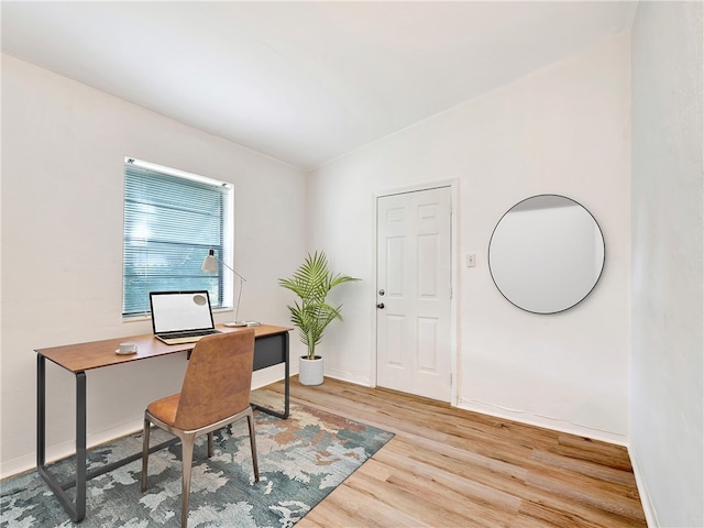 home office with hardwood / wood-style flooring and vaulted ceiling