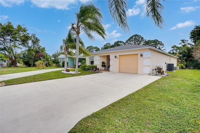 ranch-style home with a garage, a front yard, and central air condition unit