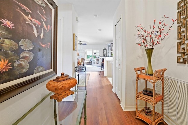 corridor with light hardwood / wood-style flooring